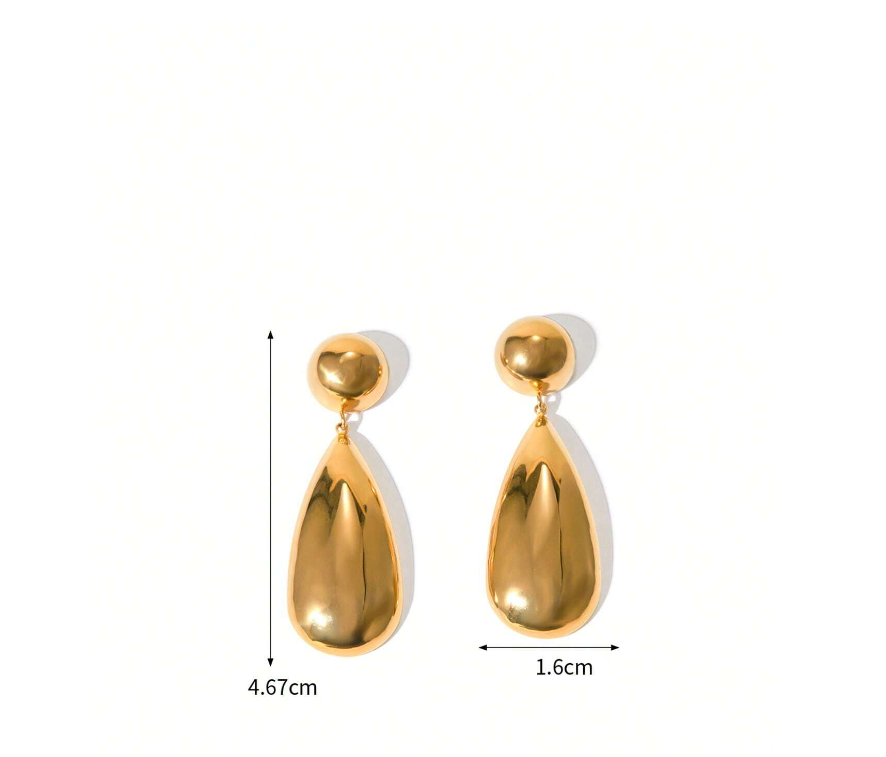 Gold water drop earrings worn for styling