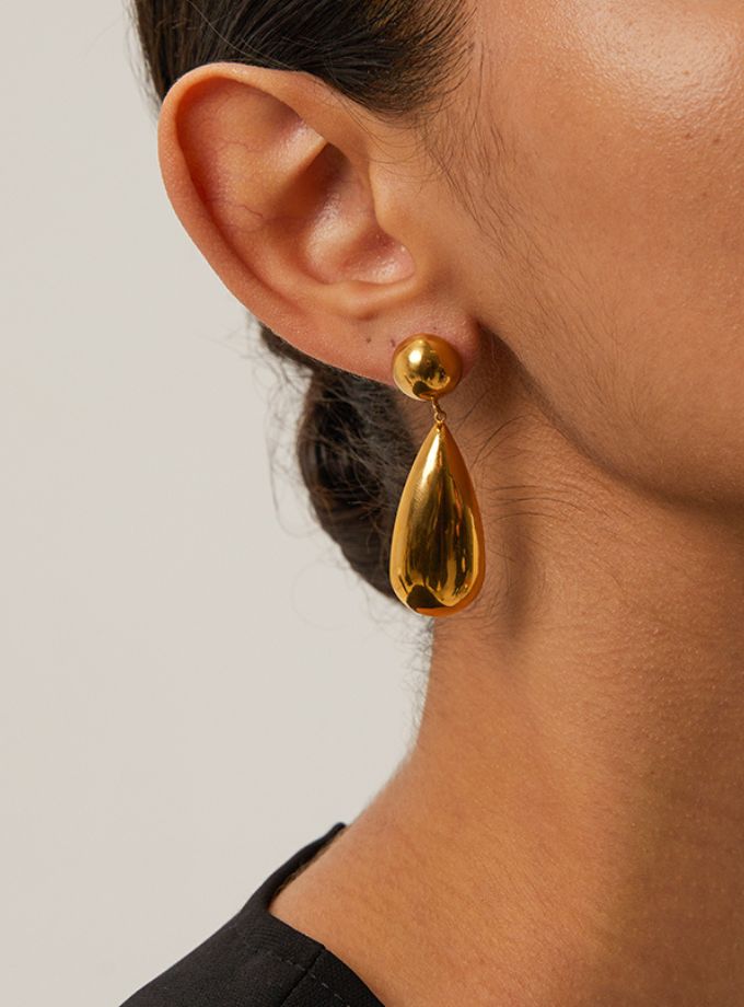Sculptural gold water drop earrings close-up