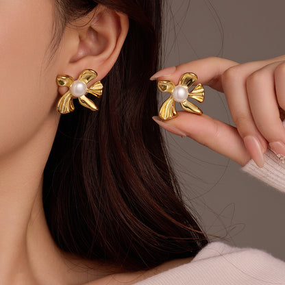 Close-up of floral gold pearl earrings