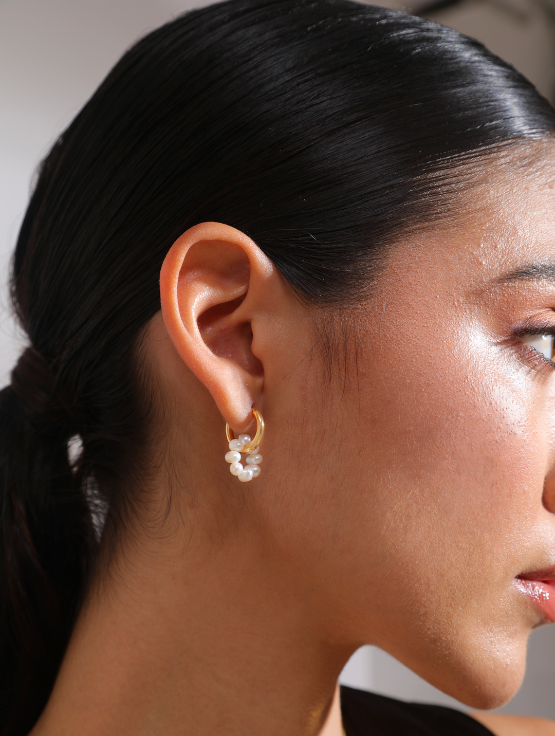 Side angle of modern pearl hoop earrings